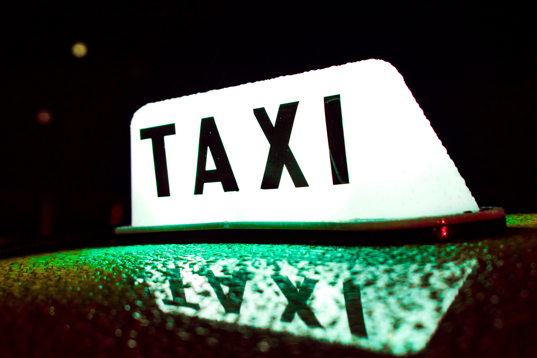 Wet Taxi Roof Light During Night Time